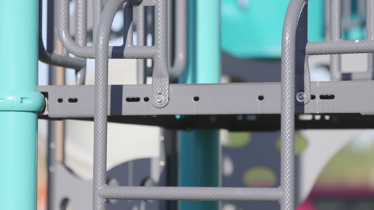 Slow tilt up a ladder in an emtpy children's playground in Phoenix Arizona.