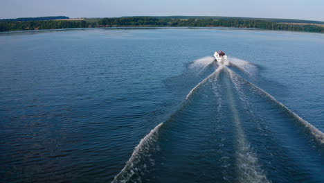 aerial shot of boat on river. aerial view of motor boat racing deep water