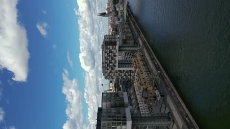 Vertical-footage-of-Kranhäuser-im-Rheinauhafen-buildings,-bank-of-the-Rhine