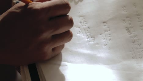 intense writing on a notebook with a pencil