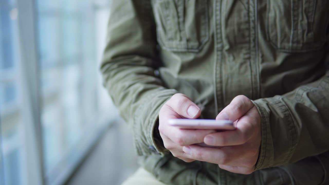 man using smartphone on metro station