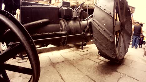 ancient tractor wheels in front of camera passersby ankara