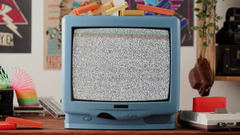 vintage retro tv with static noise and gaming consoles