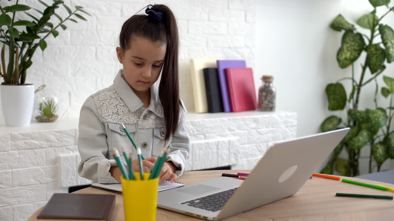 children, education and distant learning concept, little student girl with laptop computer at home