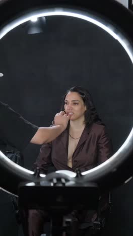 in a professional studio setting, a talented makeup artist skillfully applies various techniques to a model
