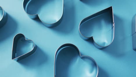 Heart-shape-cookie-cutters-on-blue-background-at-valentine's-day