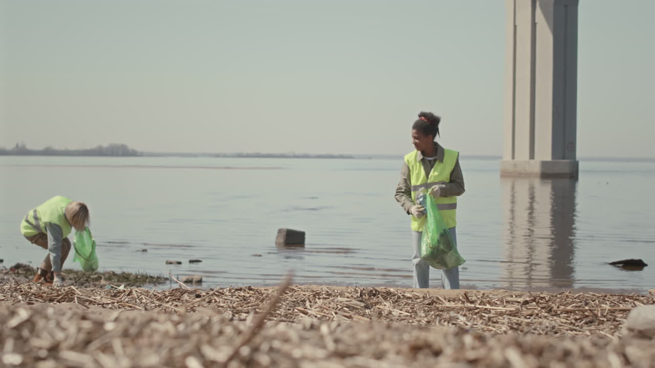 Environmental Volunteers Collecting Garbage on Shore