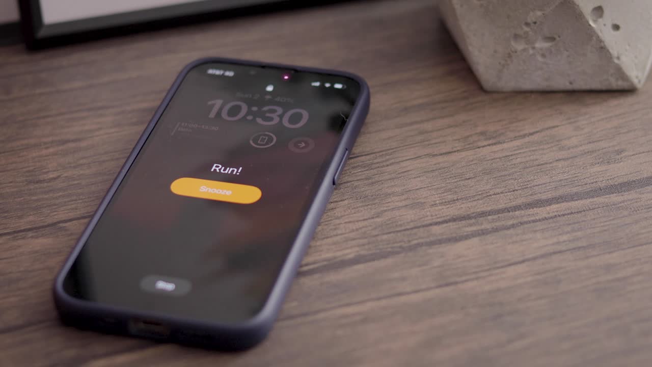 Alarm sounding on cellular phone, on the screen you can read the word: "run