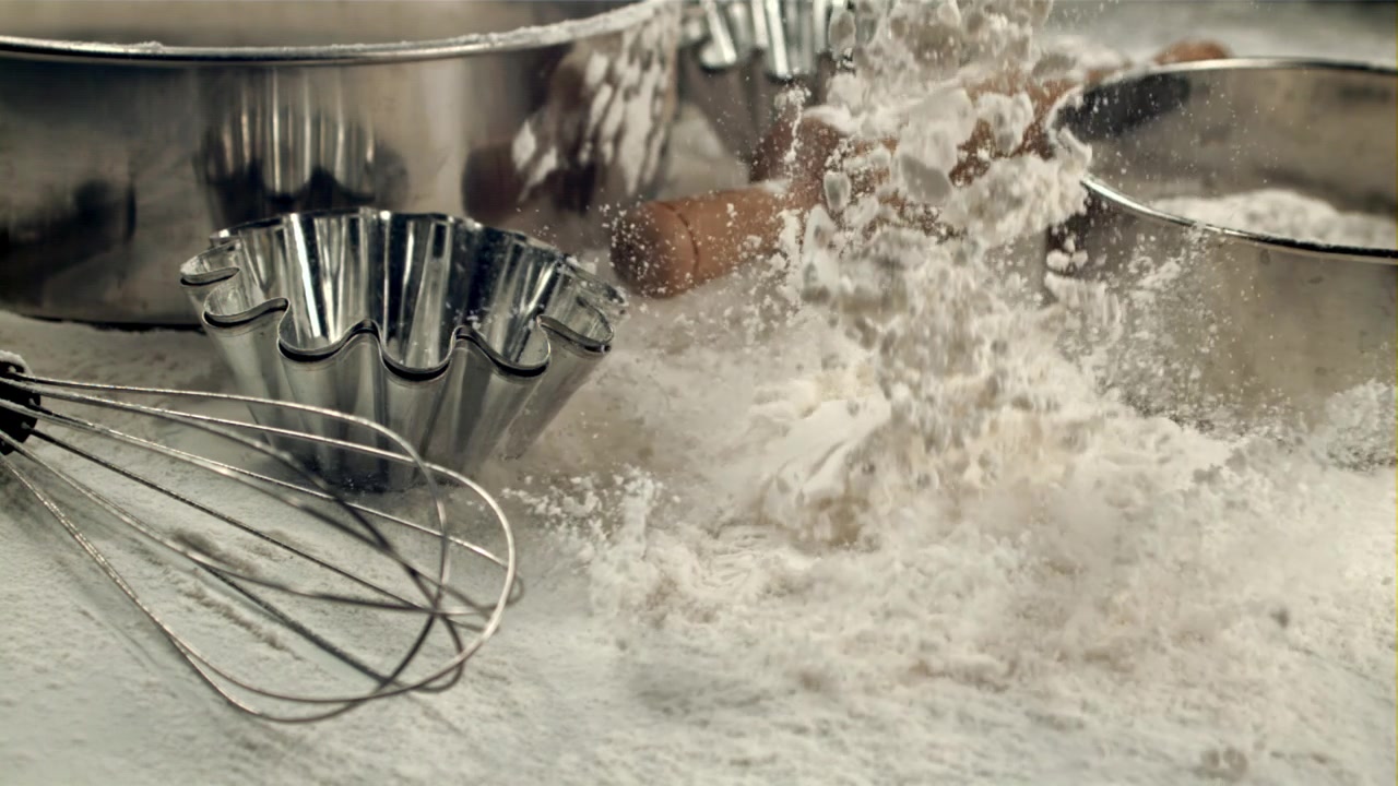Flour Falling on Baking Ingredients and Tools in Slow Motion