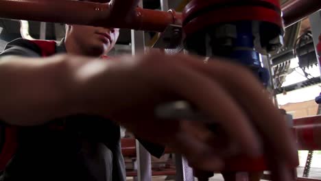 industrial worker repairing pipeline valves