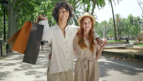 tourist couple walking with shopping bags. romantic family hugging outdoor