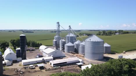 Flying-over-grain-bins-on-farm-during-summer