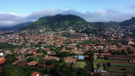 Aerial-pan-shot-of-African-homes-and-hills-in-the-suburbs-of-Yaounde,-Cameroon