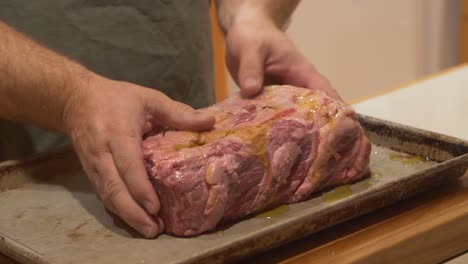 chefs adds olive oil to a prime cut of wagyu kobe beef before roasting