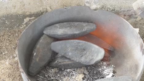 top-down view of molten lead in a foundry crucible amid a metalworking process