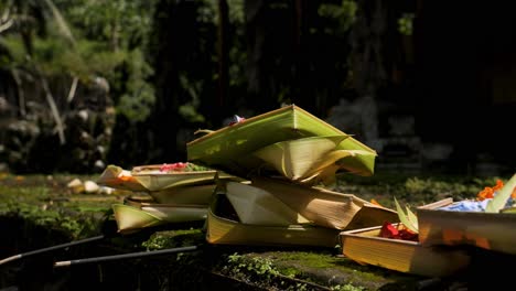 Schwenk-In-Zeitlupe,-In-Dem-Sari-Gezüchtet-Wird,-Die-Opfergaben-An-Die-Götter-Als-Zeichen-Der-Dankbarkeit-Und-Traditioneller-Kunst-Auf-Bali-In-Indonesien-In-Einem-Hinduistischen-Tempel