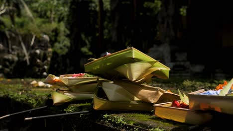 slow motion panning shot of caning sari the offerings to the gods as a sign of gratitude and traditional art on bali in indonesia in a hindu temple