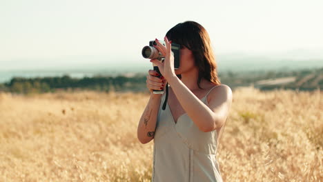 woman filming with an old camera