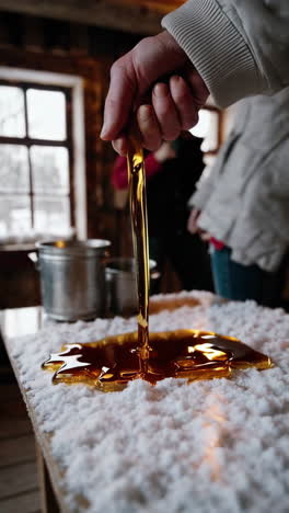 making traditional maple taffy on snow in a rustic cabin