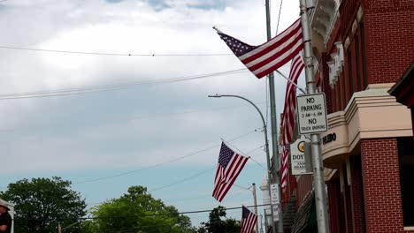 Amerikanische-Flaggen-Wehen-In-Der-Innenstadt-Von-Toledo,-Iowa