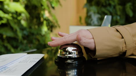 finger of a host pressing the reception bell