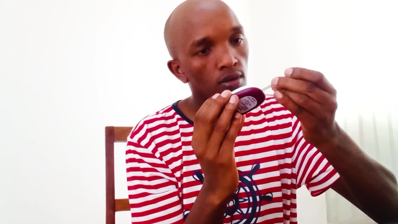An african man testing Diabetes type 2. Diabetic patient testing for sugar levels