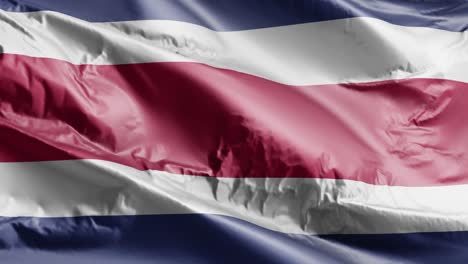 la bandera de costa rica ondeando en el bucle del viento. el estandarte costarricense balanceándose en la brisa. fondo de relleno completo. bucle de 10 segundos.