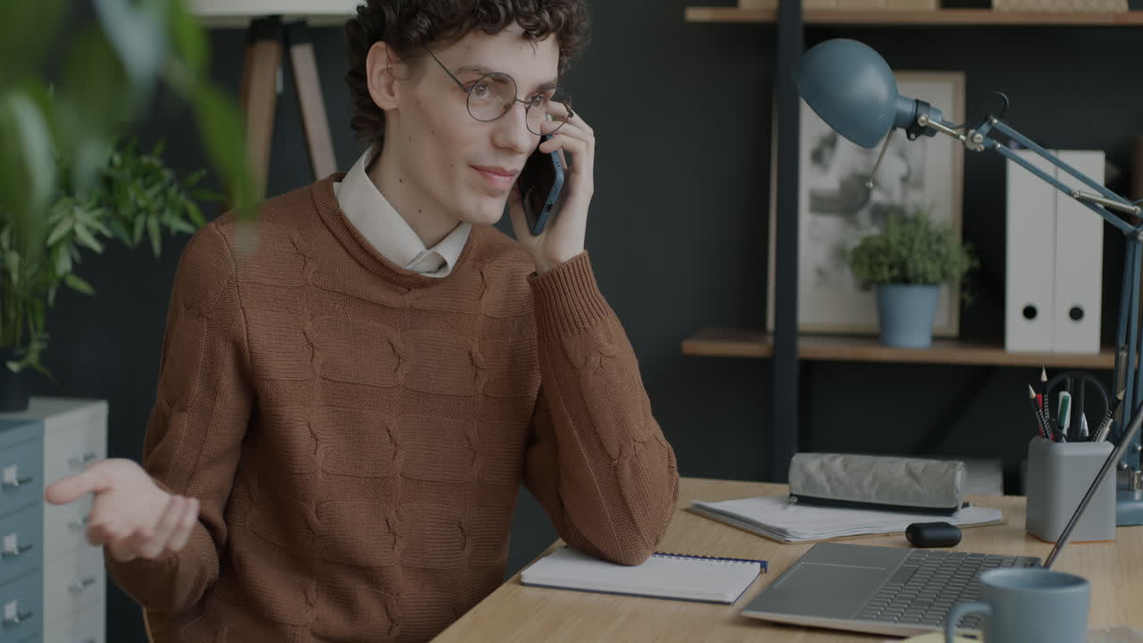 Young man on a phone call in an office