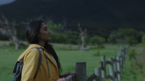 young independent indian woman hiker enjoying peaceful nature outdoors breathing fresh green countryside happy female hiking smiling calm
