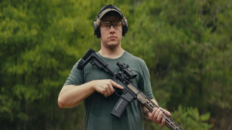 Man holding a rifle outdoors