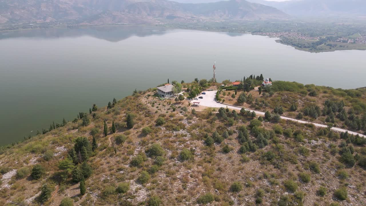 Aerial clip rotating over the top of a mountain on the lake of Kastoria, in northern Greece