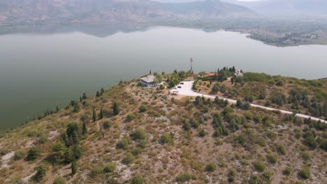 aerial clip rotating over the top of a mountain on the lake of kastoria, in northern greece