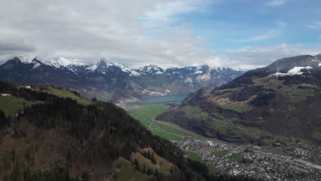 panoramic aerial of glarus, switzerland, a picturesque town embraced by snow-capped mountain peaks of the swiss alps, radiating an irresistible allure through its captivating beauty