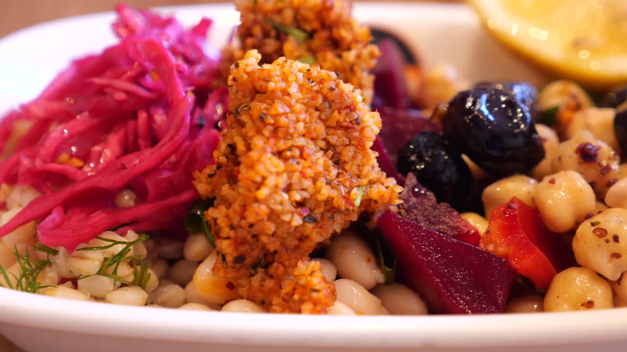 A vibrant dish of vegetarian cuisine with beans, vegetables, and grains