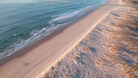 long stretch of white sand along the beach on a summer season