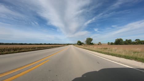 point of view footage while driving down a paved road in rural iowa