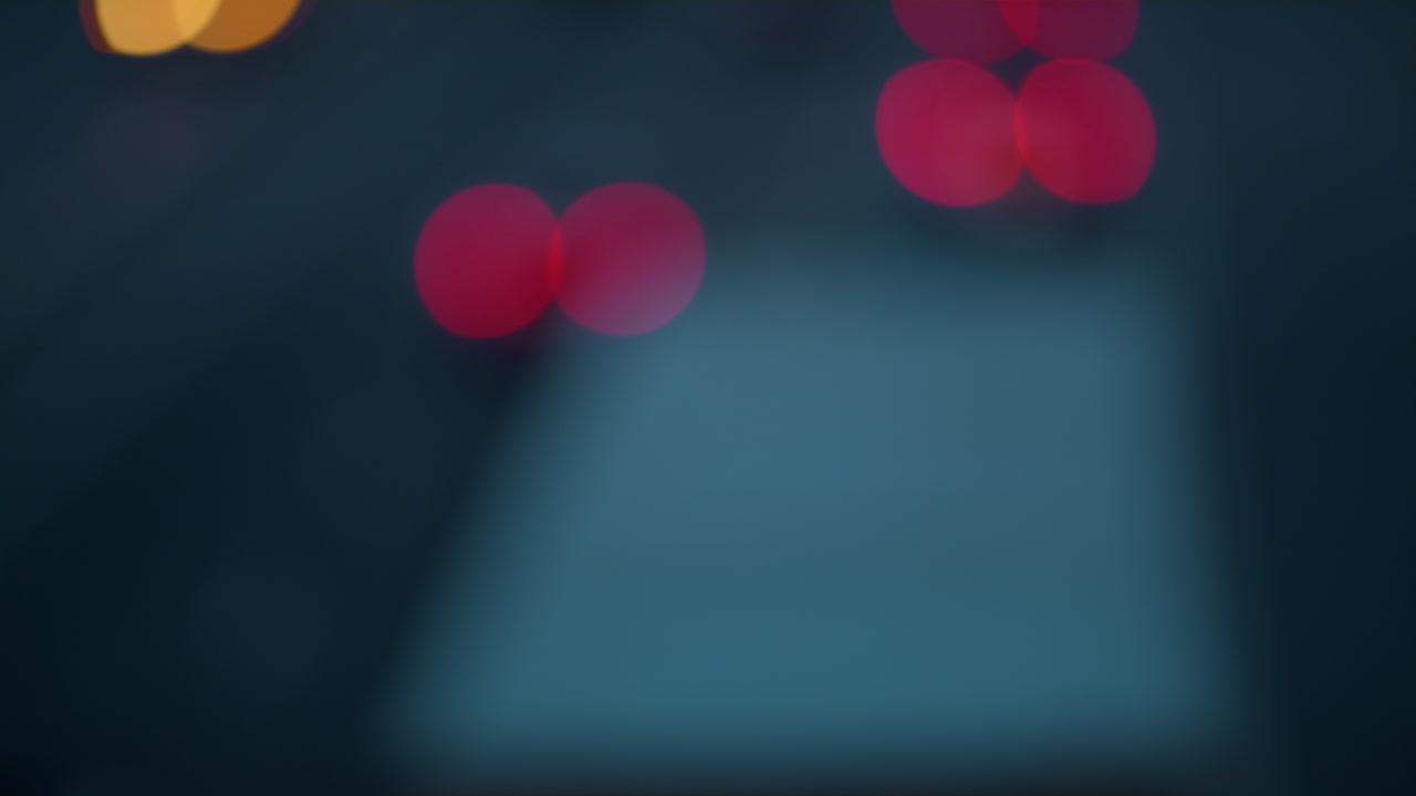 Blurred red Bokeh effect circles moving. Abstract evening city traffic concept.