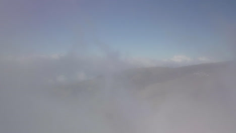 Drone-dolly-view-through-clouds-over-the-slopes-of-Haleakala-volcano-in-Hawaii