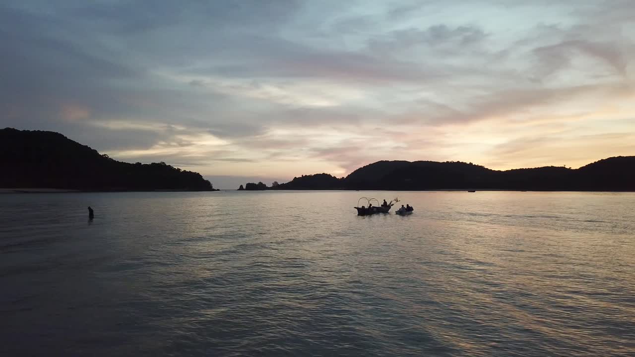 Sunset Silhouette of Fishermen in Tropical Ocean