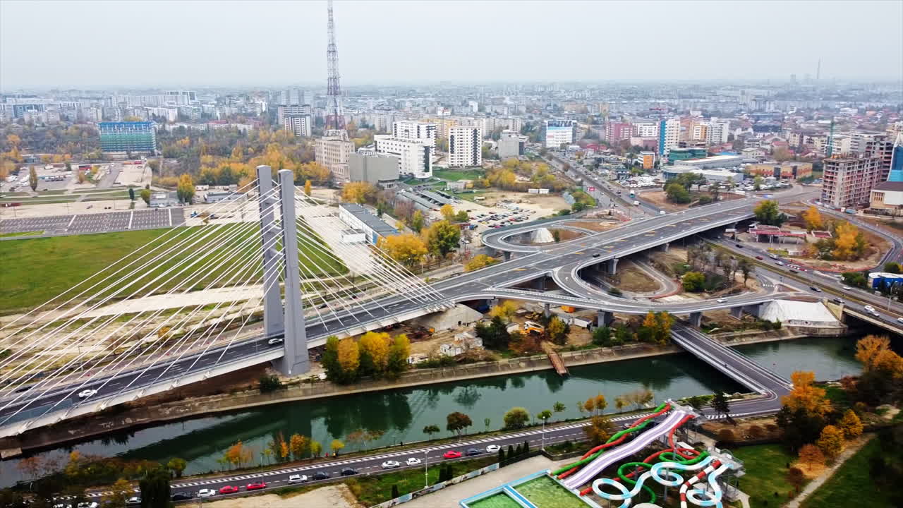 Ciurel passage, bridge over a river with moving cars, construction works near it. View from the drone. Bucharest, Romania