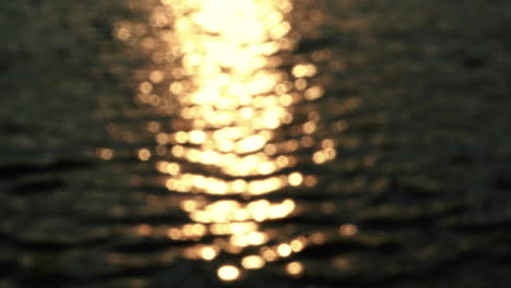 blurred golden light reflected on the lake water surface