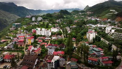 aerial establishing dolly over sapa city, vietnam, with its scenic landscapes, terraced fields, and mist-covered mountains, morning light