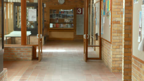 Excited-classmates-running-in-corridor