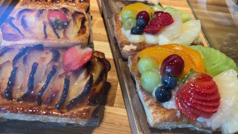 assorted fruit tarts on a wooden board, ready to serve