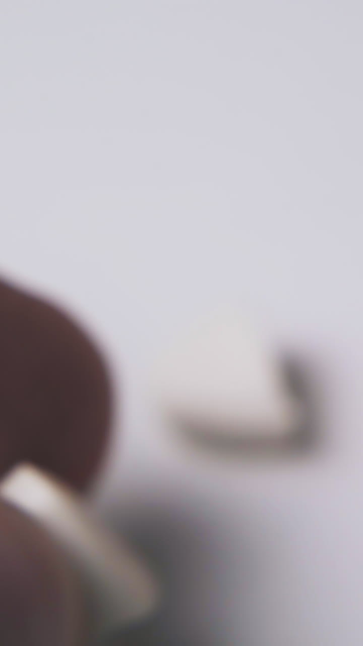 ill person breaks white oval medical pill to halves by fingers on light background extreme close view