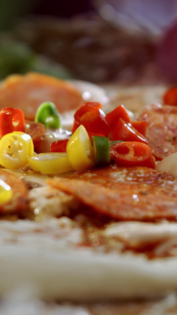 Making a pizza with pepperoni and chili peppers