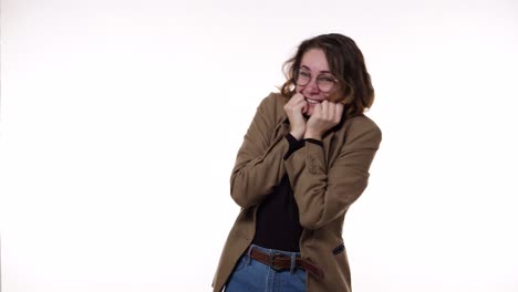 surprised excited happy european woman on white background. girl with curly hair and positive stylish appearance shows yes gesture of victory,she achieved result, goals. gesturing 'yes', 'wow'