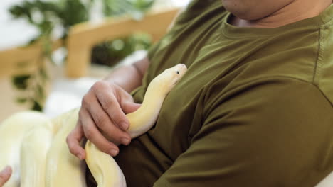 man with snake indoors