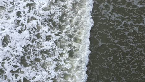Aerial-from-the-top-drone-view-of-waves-splashing-at-the-shore-of-General-Villamil-beach-in-Ecuador