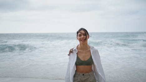 Girl-rejoicing-sea-waves-summer-cloudy-day.-Smiling-woman-running-to-foamy-water